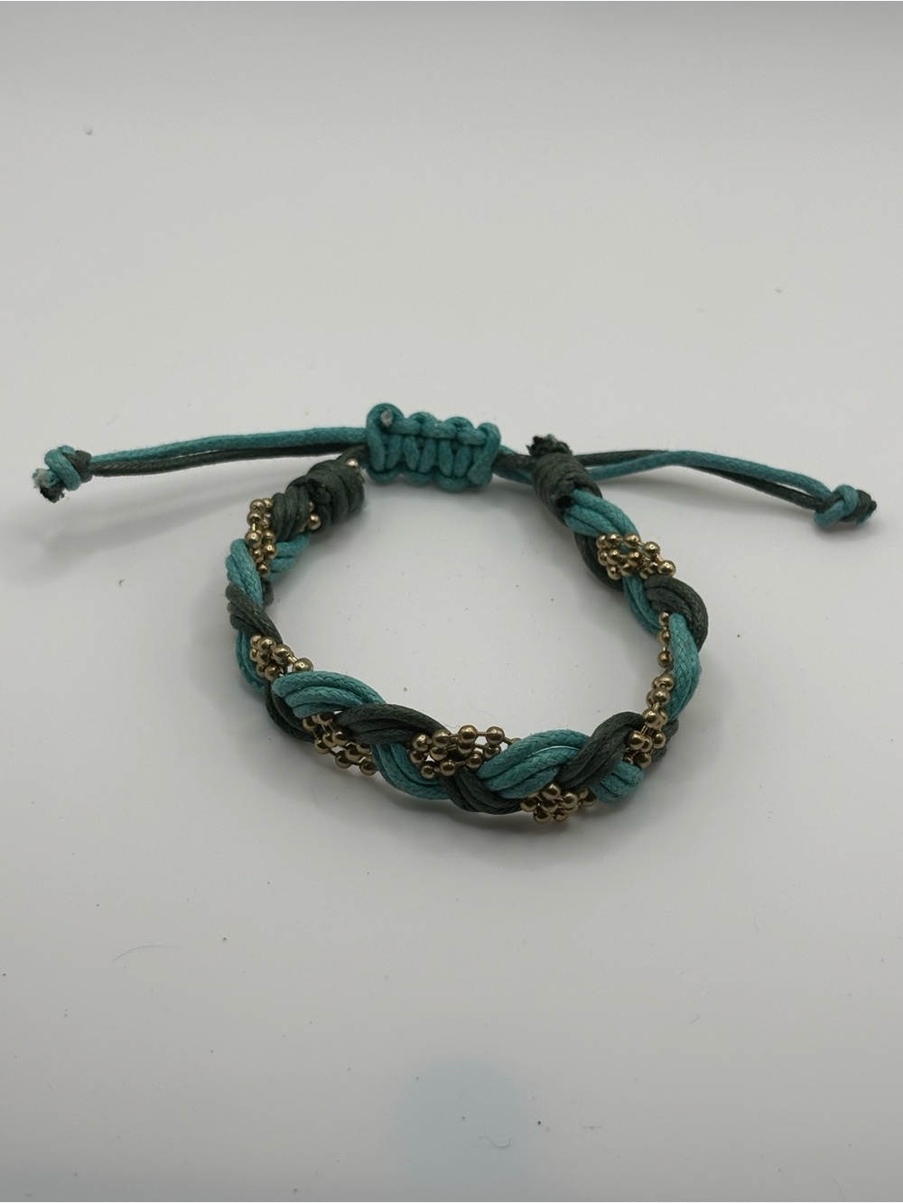 Bohemian theme gold tone bead, blue & navy cord braided adjustable bracelet